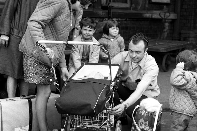 A family get ready to board a train for Wigan wakes weeks at North Western Station 1969.