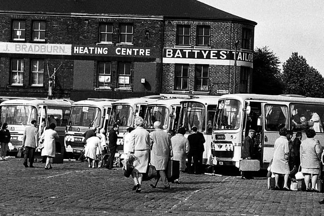 Wiganers meet at the Market Square to board coaches to the seaside during the annual wakes weeks holiday July 1969