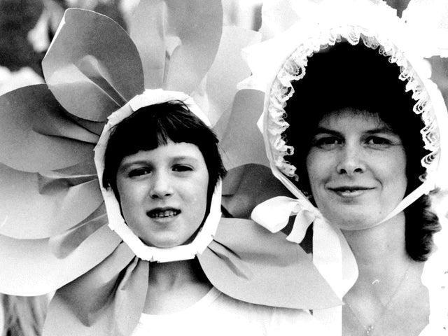 Fundraising assistant Barbara Barrett with Kate Earl, six, on the Wheatfields float in June 1987.