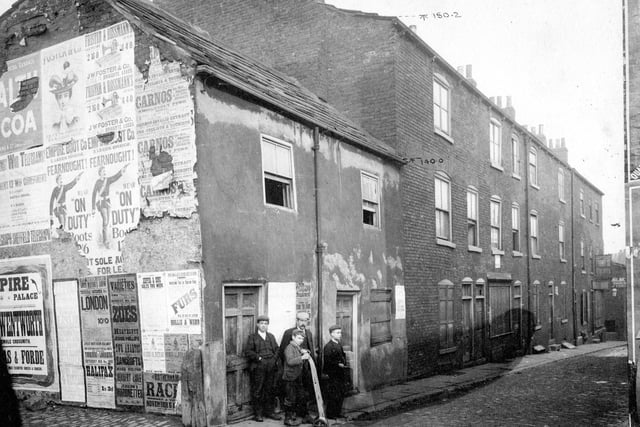 Nelson Street was situated parallel to Union Street. A small group of people are at the end of the street. One boy is holding a porters' wheels.