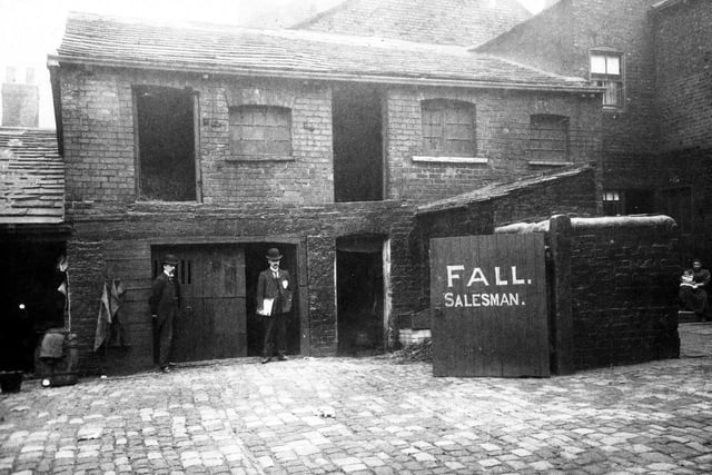 Premises of William Fall (Fish and Game Salesman) at Wilson's Yard on Duke Street. The photo was taken as part of an official enquiry into Leeds insanitary areas - hence men in bowler hats appear to be undertaking an inspection.