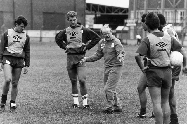 Leeds United manager Billy Bremner with his players on the training ground.