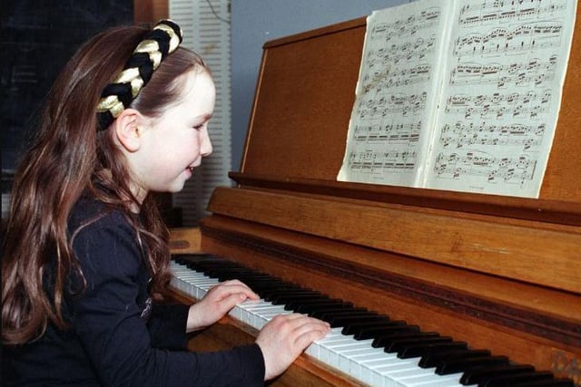 Louisa Brown (7) performs her piano solo in 1999