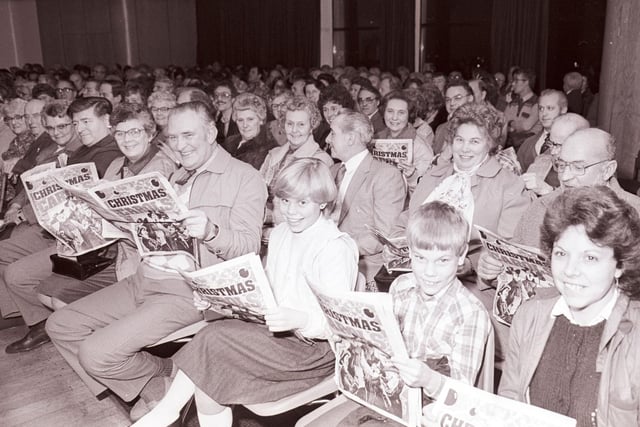Crowds grinned as they waited for the start of the carol concert, equipped with their festive programmes.