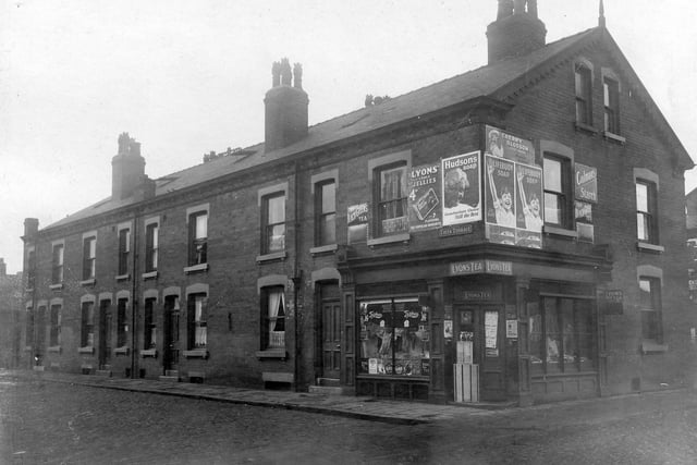 Edith Terrace in Sheepscar, a short terrace off Bristol Street, seen in the foreground. A corner shop advertises Lyons Tea, Hudson's soap, Lifebuoy soap, Cherry Blossom boot polish and Colman's starch among others.