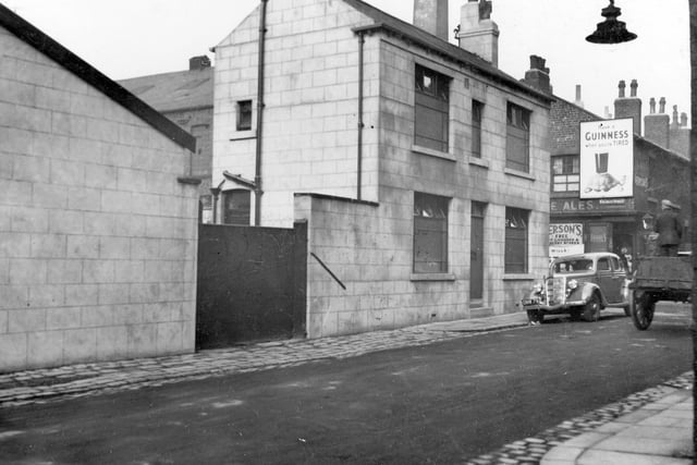 The.Premises on Little Russell Street in Holbeck. To the right can be seen Coleman Street, with corner shop. Advert for Guinness above the door.
