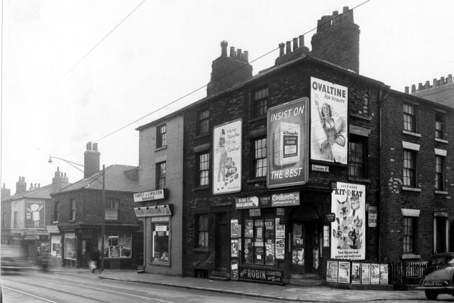A corner shop at North Street and Stamford Street in Sheepscar. The shop is covered in posters advertising Kit-E-Kat, Ovaltine, Cookeen, McDougall's Flour etc.