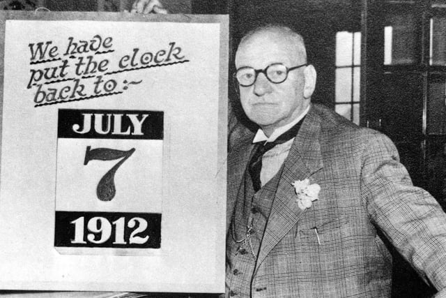 Harry Ramsden at his White Cross fish and chip restaurant in July 1952, with display board 'we have put the clock back to July 7th 1912'