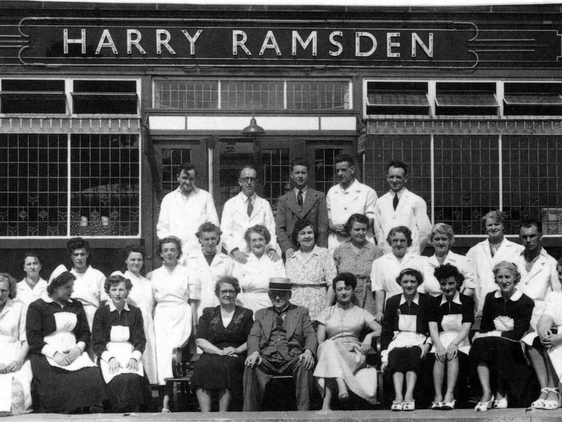 Seated at the centre of the front row is Harry Ramsden. He is photographed with his staff outside the fish restaurant at White Cross, Guiseley.