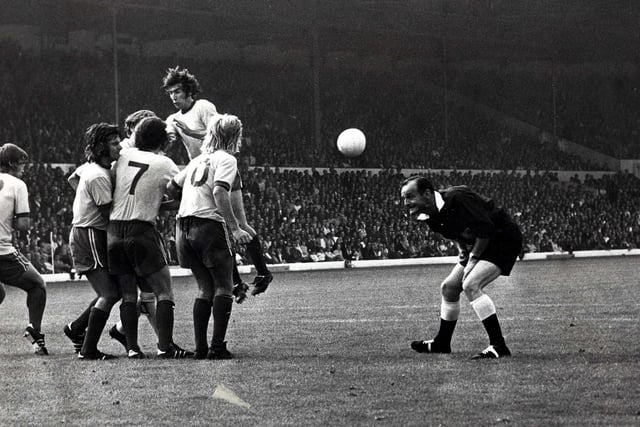 John Giles fires in a free kick as the referee ducks for cover.