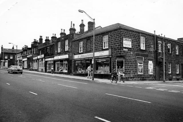 Otley Road showing the junction with Cottage Road on the right. Shops in the picture include H. Moorhouse, grocers, Mayfair Fashions and J. C. Cook, butcher.