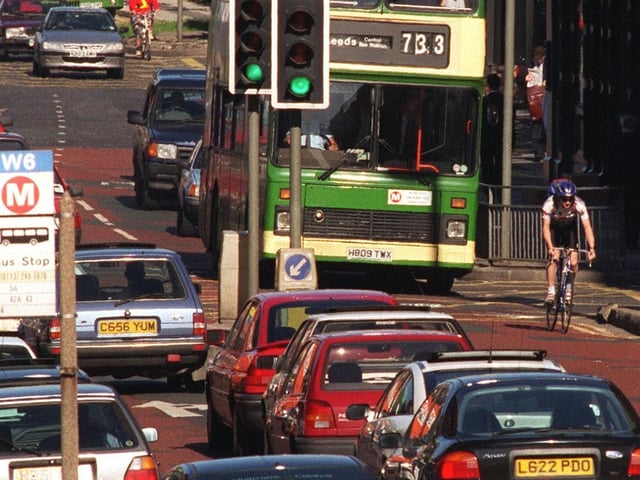 A cyclist battles his way through the early morning traffic on No Car Day.