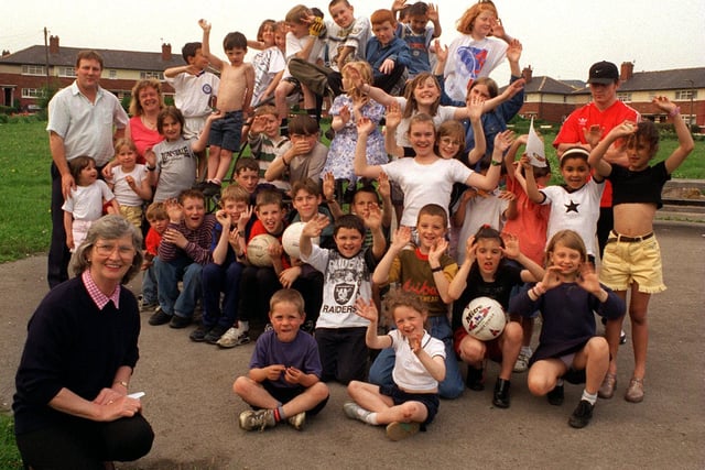 Blanche Holmes (front) with youngsters who meet every Thursday to play games on the green at Torre Crescent. Blanche is organiser for the Sumrie Residents Association who were bidding for millennium cash to build a leisure centre.