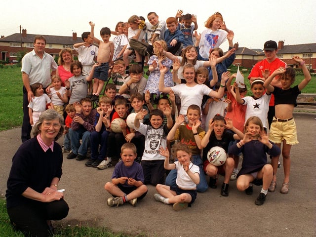 Blanche Holmes (front) with youngsters who meet every Thursday to play games on the green at Torre Crescent. Blanche is organiser for the Sumrie Residents Association who were bidding for millennium cash to build a leisure centre.