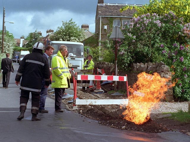 Workmen laying cable TV on West End Lane accidentally cut through a gas services pipe causing a four foot flame near a house, pictured fire and gas officers inspecting the damage.