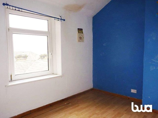 The first bedroom is a decent size with large windows overlooking the street.