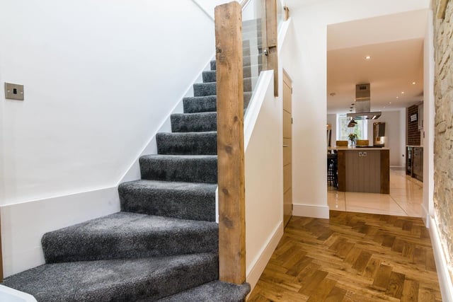 The stone period features are juxtaposed perfectly with the modern wood flooring, curved staircase and glass panelling.