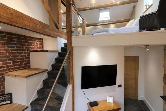 The upstairs hallway (a converted former bedroom) has been designed as another lounge area and also leads up to the mezzanine floor.