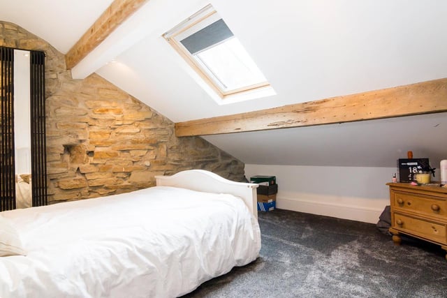 Velux windows and window to the side give the room a good burst of natural light, despite being a converted attic bedroom.