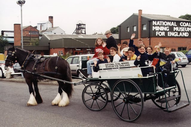 In this undated picture, a group of schoolchildren enjoy a trip in a horse and carriage.