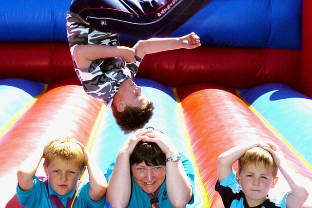 7th Blackpool Scout Group family camp at Fylde Scout HQ, St. Annes. 'Being prepared' on the bouncy castle are, from left, Adam Fletcher, Beaver Leader Karen Berry and Daniel Clarke,while Callum Vernon practises his somersaults.