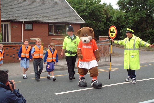 Pupils from St Nicholas School in Blackpool cross the road with Bloomfield Bear as part of walk to school week