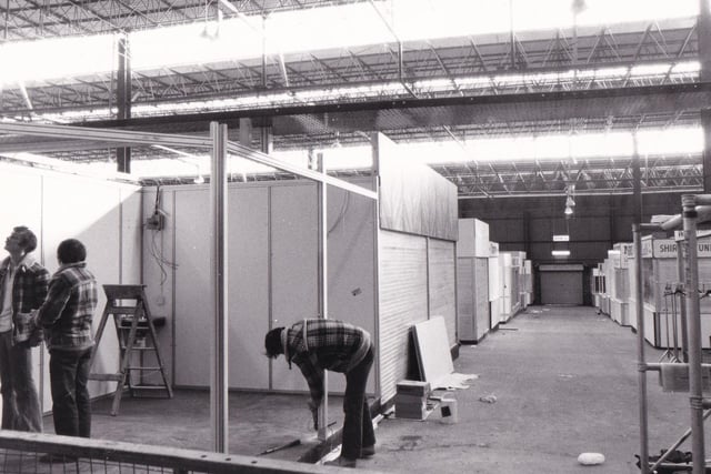 Workmen put the finishing touches to some of the new stalls in the new look market in November 1981.
