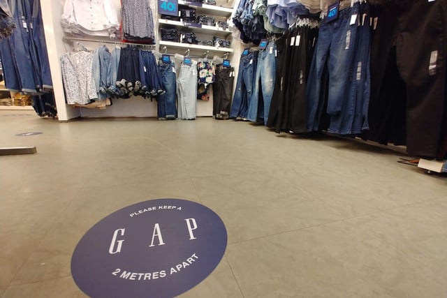 'Please keep a GAP' floor stickers have been installed throughout the store.