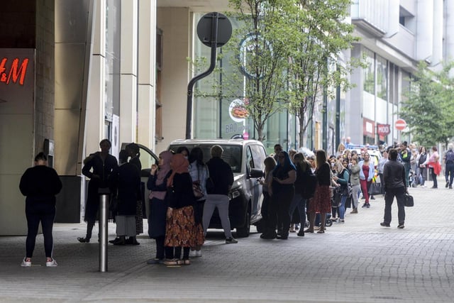 Huge socially distant queues formed outside several city centre shops