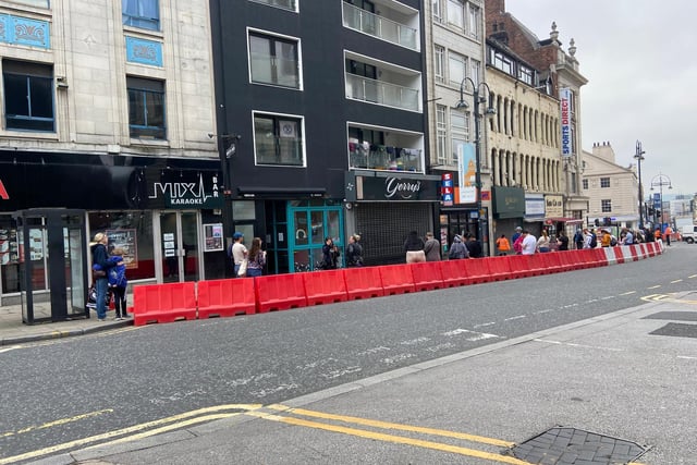 The new widened pavements came into their own as shoppers queued down the street
