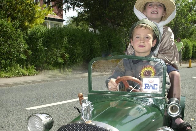 Luke Brunwell (7) and Anya Hassett (6) in their vintage model car in 2002