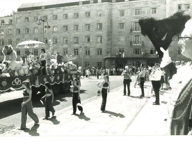 The parade makes its way to the Leeds Civic Hall in June 1976.