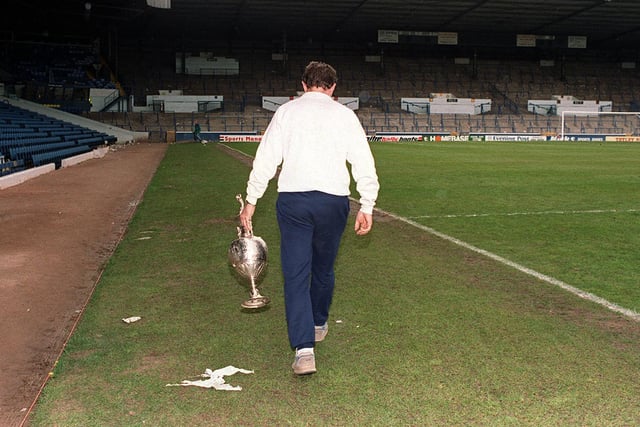 An iconic photo of Howard Wilkinson with the First Division trophy at the end of a day of celebration.