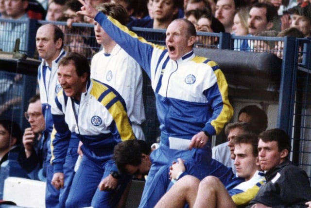 An animated Howard Wilkinson and his coaching team in the Elland Road dug out shout out to the players during a game.