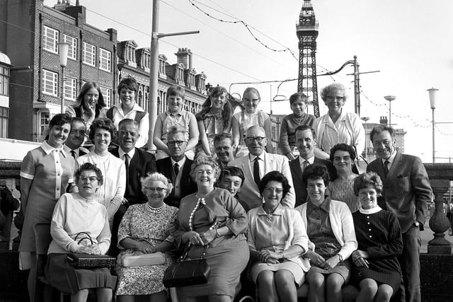 Wigan folk enjoy a group photograph with iconic Blackpool Tower in the background during their wakes weeks holiday in 1969
