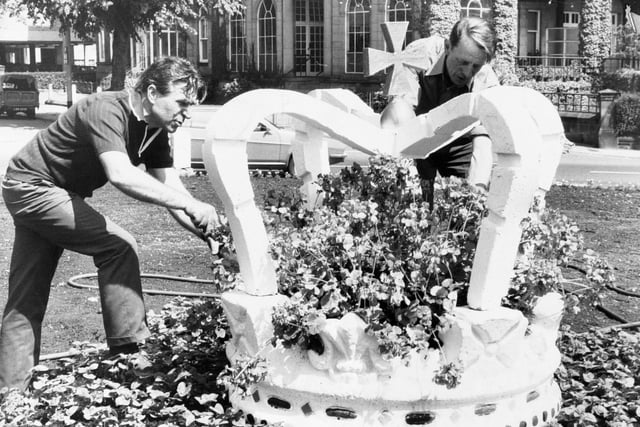 Workmen put plants around a concrete coronation crown on the Prince of Wales roundabout at Harrogate. Pictured, on the left, is supervisor Jack Harding with Alan Clark.