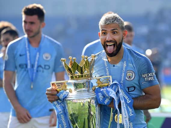 Sergio Aguero of Manchester City celebrates with the Premier League Trophy after winning the title.