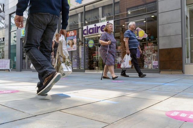 Shoppers are seen following guidelines as shops reopened for the first time in almost three months. Thousands of people descended on the city centre on Monday.