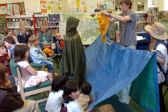 Local youngsters help to create a jungle camp during the talk by jungle explorer and author Simon Chapman, right, at Prestons Harris Library