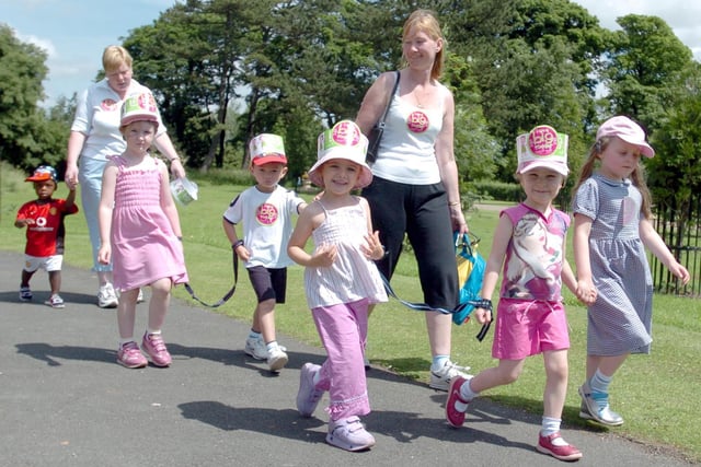 From left, Jessica France, Bethany Duckworth and Niamh Teeling lead the Big Toddle through Grange Park, Preston