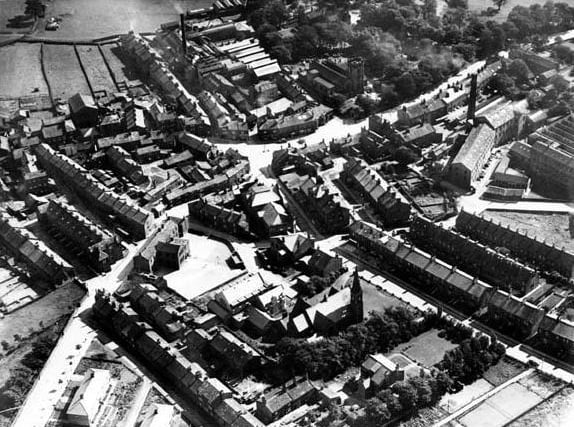 An aerial view of Guiseley thought to be pre-war. St. Oswalds Church is in the top right corner, towards the centre on the edge of the wooded area. The road passing the church is The Green.