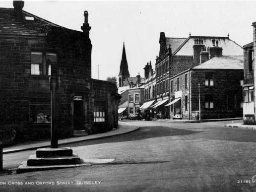 Towngate, Guiseley. These Saxon Cross and village stocks are now located in a garden of rest area which is set back from the road, to the right of this photograph. Oxford Road is in the centre.