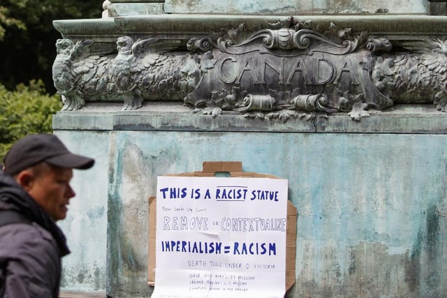A sign left near a statue of Queen Victoria in Hyde Park. The statue - and the nearby statue of Sir Robert Peel - has been the subject of a petition for its removal