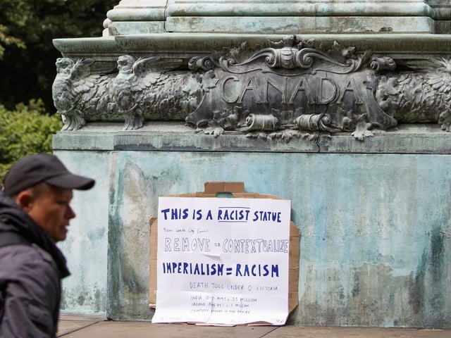 A sign left near a statue of Queen Victoria in Hyde Park. The statue - and the nearby statue of Sir Robert Peel - has been the subject of a petition for its removal