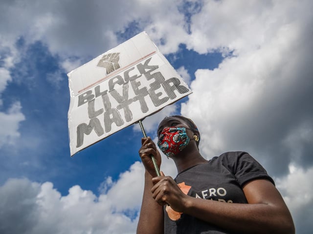 A woman holds a banner during the protest