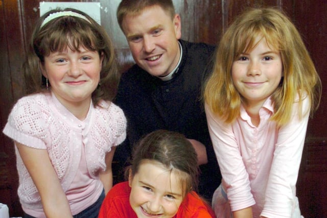 Father Rick Bunday offers treasure hunt advice to, from left, Sophie Bagwell, Olivia Clare and Natalie Uttingealane at the summer fair at St Michael and All Angels with St Mark, in Ashton, Preston