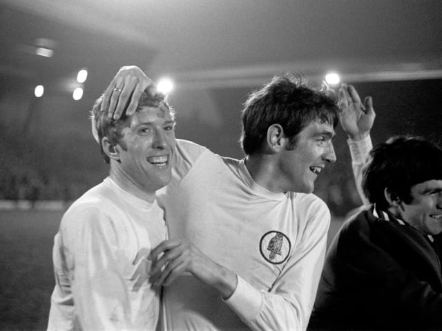 Mick Jones and Norman Hunter (right) celebrate after wrapping up the First Division title at Anfield.