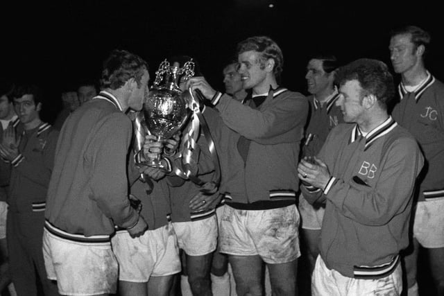 Striker Mick Jones kisses the silverware as Leeds United are presented with the First Division trophy.
