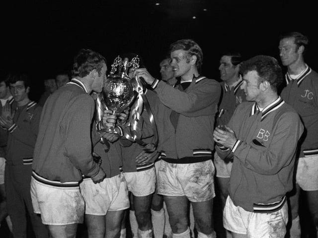 Striker Mick Jones kisses the silverware as Leeds United are presented with the First Division trophy.