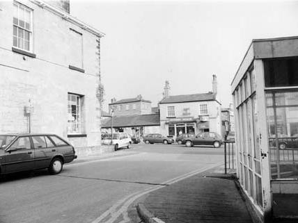Castle Gate, looking towards Market Place. Wetherby House is seen on the left. On the right is the edge of the bus station. In the background on Market Place is the Wetherby Whaler  and The Paper Shop newsagents.